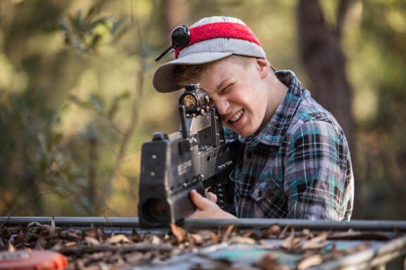 A kid enjoying laser tag on the weekend